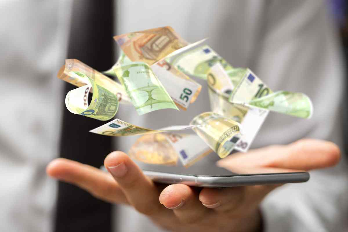 uomo con cellulare e soldi